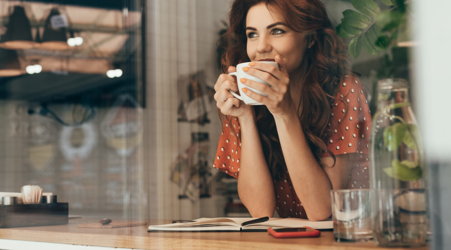 a woman enjoyig her coffee